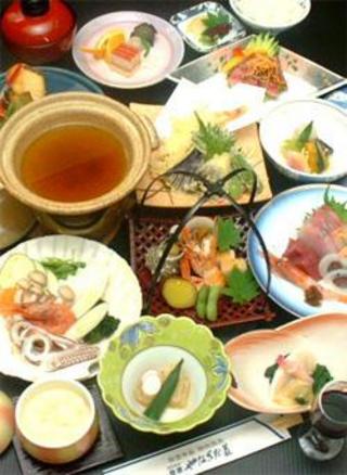 さしみ、天ぷら、茶わん蒸し、海鮮鍋などが並べられた料理の写真